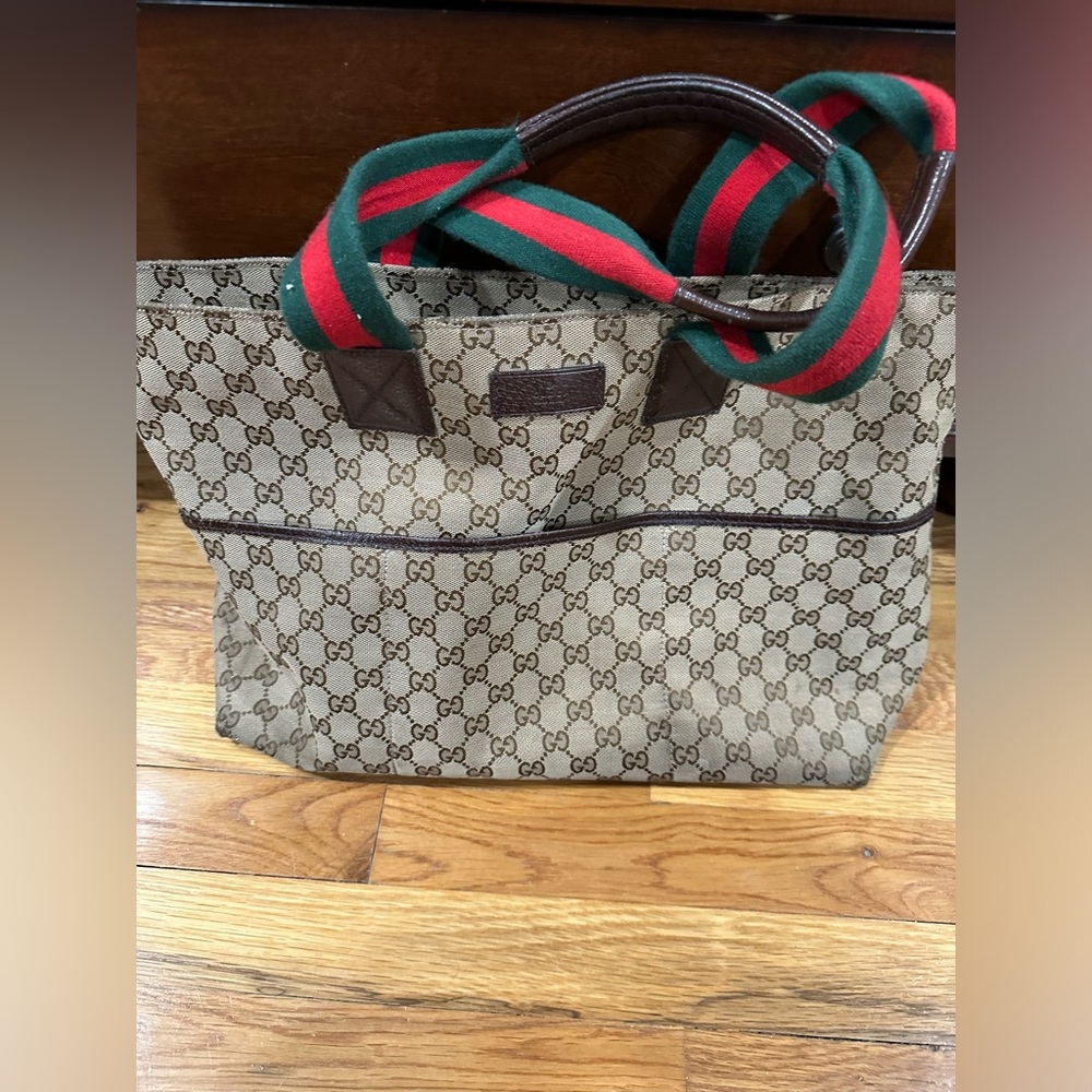 GUC Gucci diaper bag has definite wear and tear